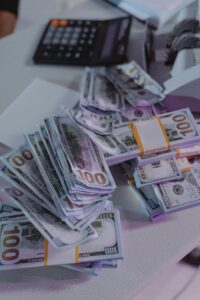 cash flow management and budgeting Stacks of hundred-dollar bills on a table.