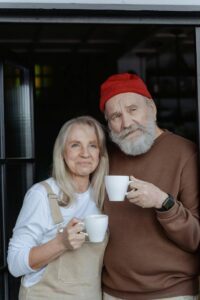 retirement planning services Happy older couple hugging each other as they enjoy their morning coffee.