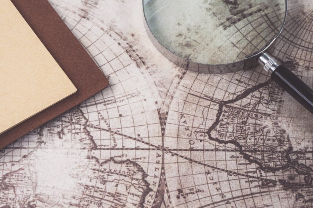 Charting Opportunities Map with notebook and magnifying glass laying on top