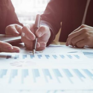 fiduciary financial advisor Two people looking over pages of charts