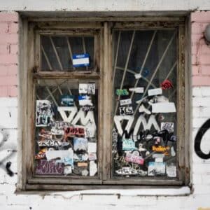 Graffiti and stickers on windows of an old building