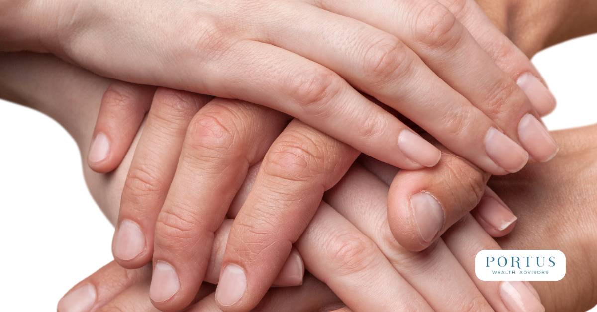 Hands of a family stacked on top of each other.