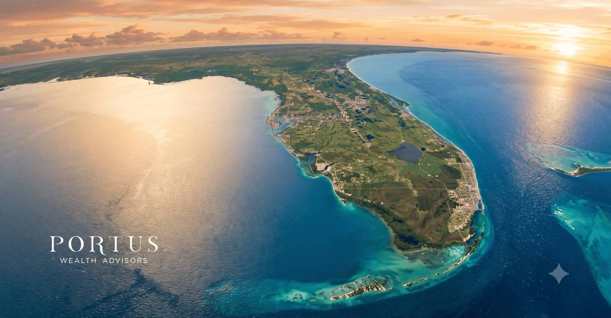 A wide aerial of Florida's coastline from above, ideally showing both the Atlantic and the Gulf in the same frame or suggesting the breadth of the state -- something that immediately communicates "Florida" without being tied to Miami, Orlando, or any single market. A high-altitude shot showing the peninsula with water on both sides, golden hour light, is striking and immediately distinctive. Portus Wealth Advisors logo in the bottoom left corner.