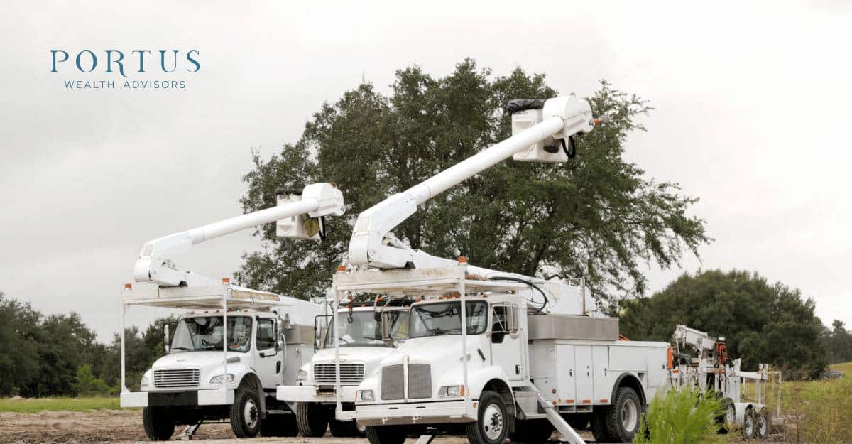 Three white work trucks lined up on a country road, the the "exit planning for trades business owners" blog post. Portus Wealth Advisors logo in the top left.