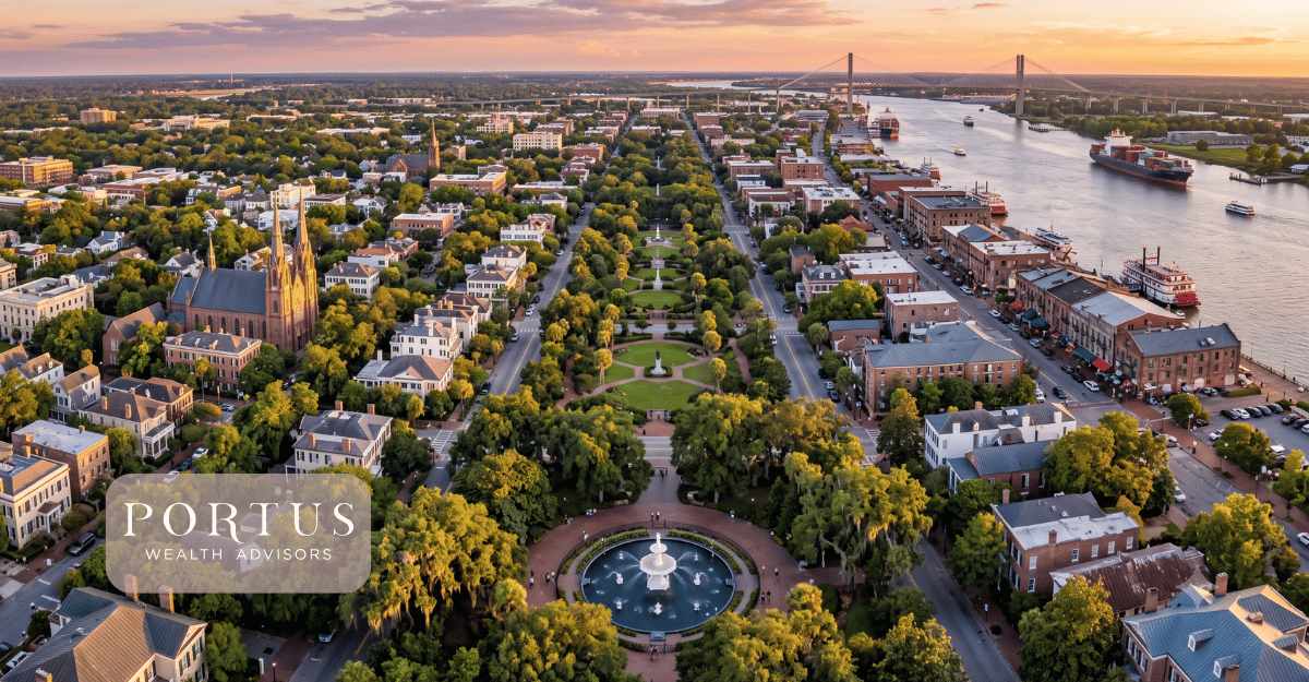 An aerial of Savannah's historic district -- the grid of squares, the Forsyth Park fountain, or the riverfront district from above at golden hour for the "selling your business in georgia" blog post. Portus Wealth Advisors logo in the bottom left.